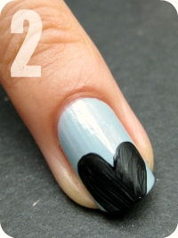 Then use a nail art brush to draw the shape of a heart with black nail