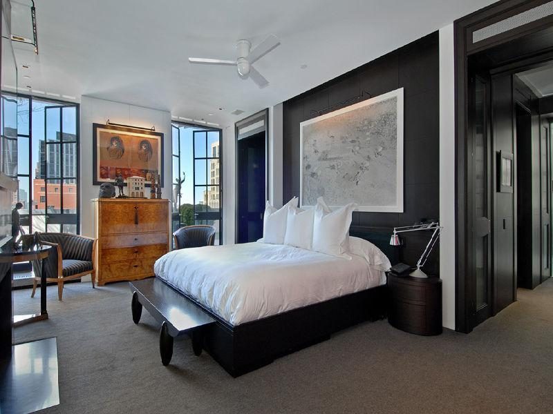 Photo of modern bedroom with dark brown wall and bed