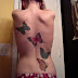 Green butterfly tattoo on back