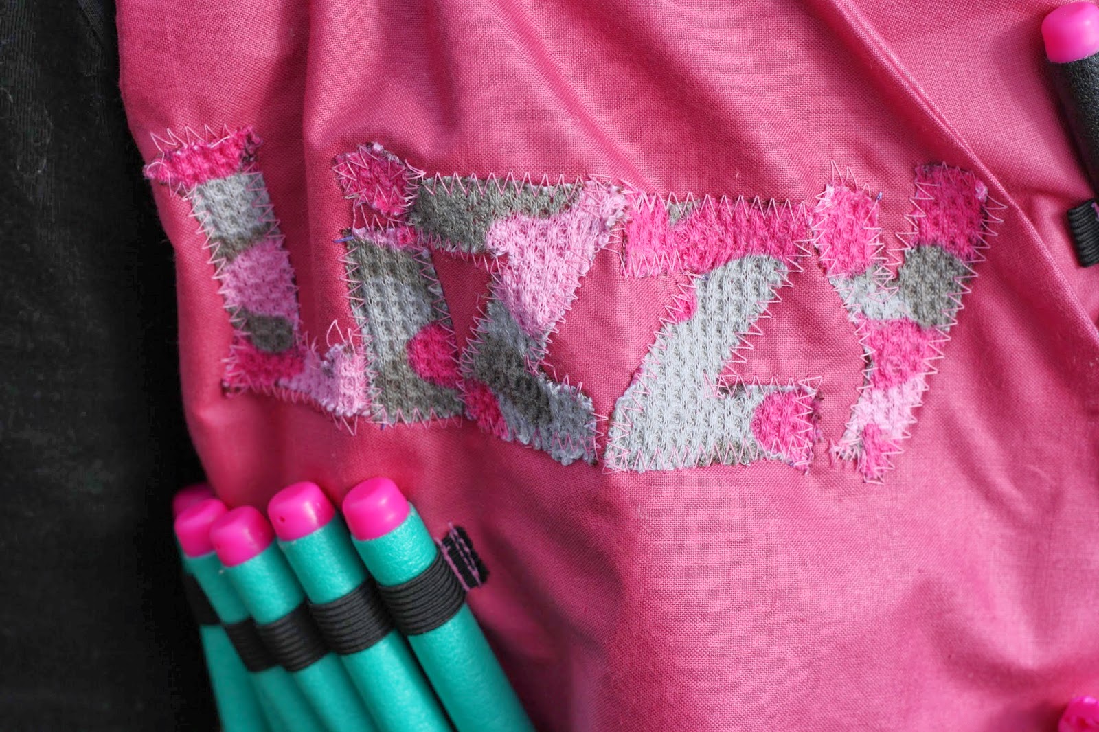 I also made some elastic holders for her guns on the back of the vest, and another one on the