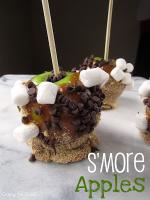 S'more Caramel Apples green apple on a stick with caramel, graham crackers, chocolate chips and marshmallows