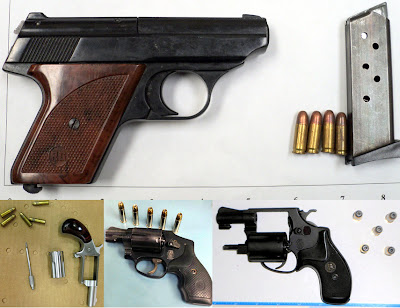 Loaded guns discovered in carry-on bags.