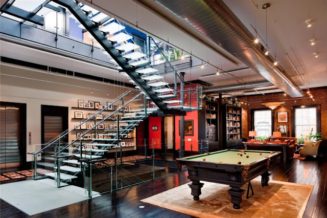 Photo of pool table on the second floor of Tribeca triplex along with glass staircase 