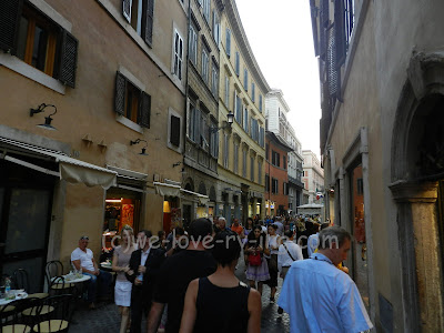 The narrow street is filled with people