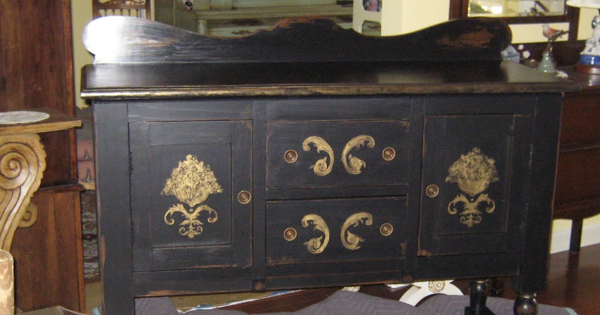 LYNDA BERGMAN DECORATIVE ARTISAN TOUCHING UP PAINT ON A BLACK & GOLD