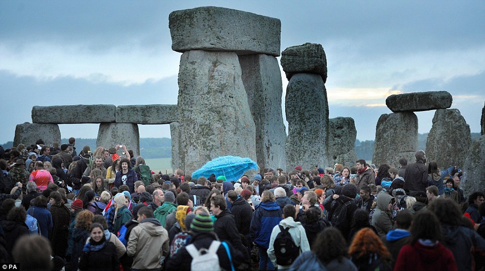 Can anyone tell us when the sun is coming up? 18,000 gather at a cloudy Stonehenge for all-night summer solstice party