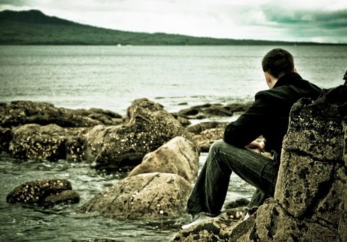 A sad man looking out to sea