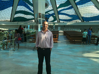 a man standing in a large room with a dome ceiling and people