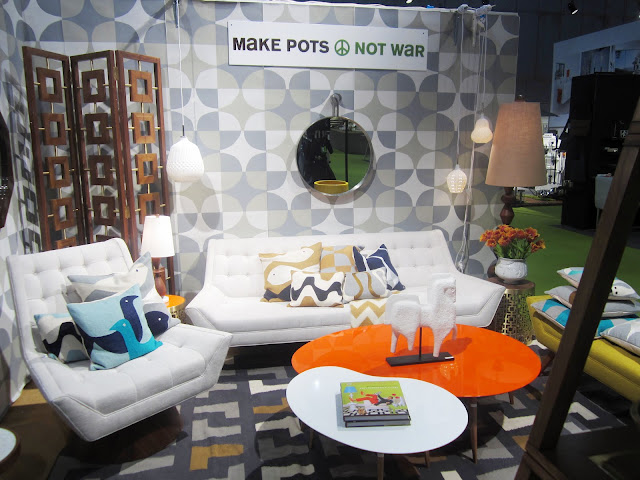 White and Orange kidney shaped coffee tables at Jonathan Adler's booth from the New York International Gift Fair 