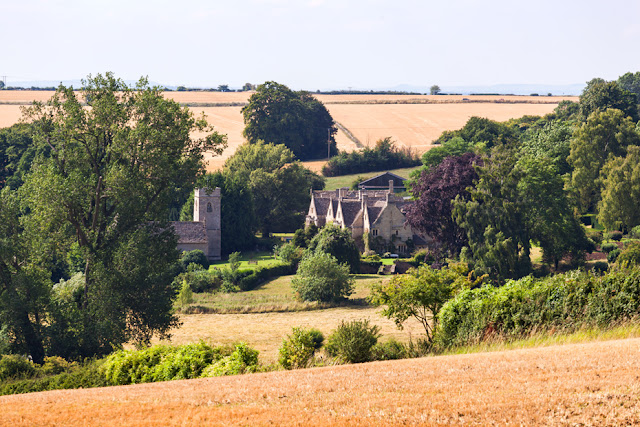 Asthall Manor and church on the Cotswold countryside by Martyn Ferry Photography