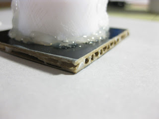 Adding glue to the edges of the LED paper lamp base. 