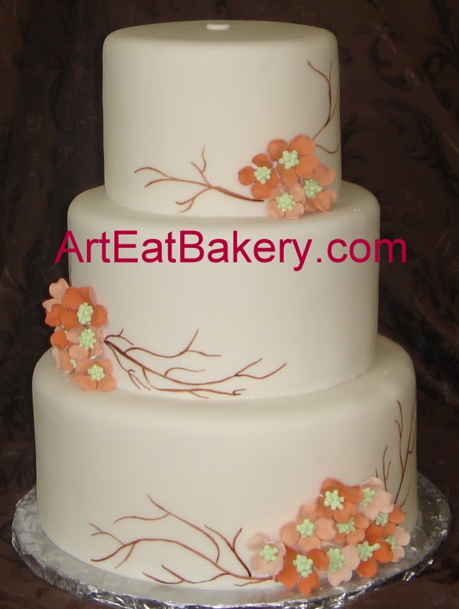 Three tier round fondant wedding cake with custom peach and salmon dogwood 
