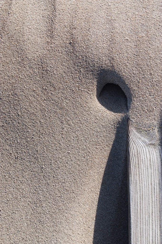 hole and wood in sand