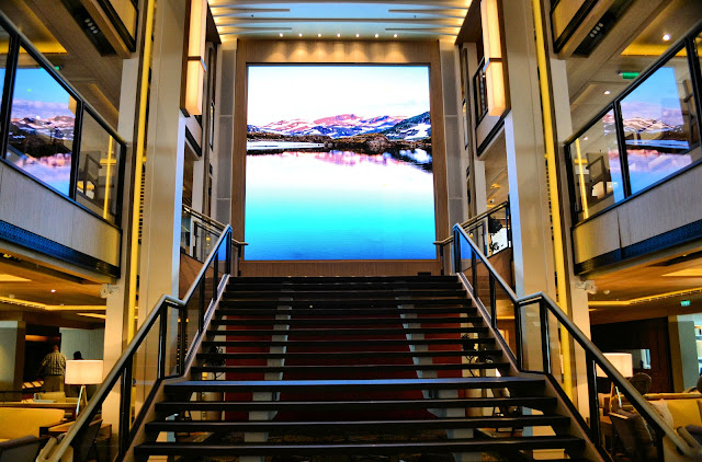 Welcome to the Living Room, a three-deck atrium surrounded by cozy nooks, a library, the concierge and a bar. Marvel at the two-deck monitor at the top of the stairs that cycles through dazzling high-res images of places yet to be explored. 