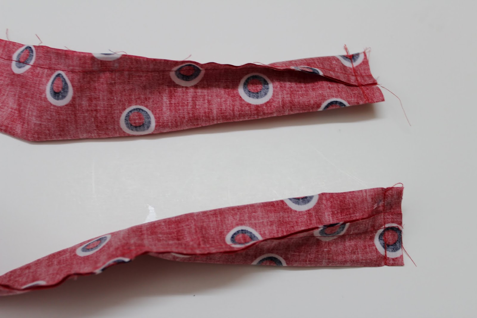 Turn the seam such that it comes to the center. Sew along 1 shorter end.