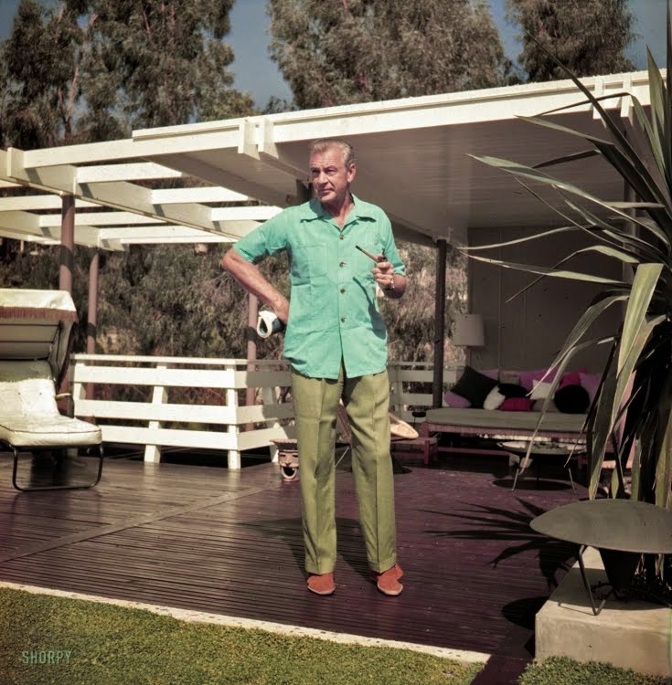 September 1954.  Actor Gary Cooper at home in California smoking pipe.