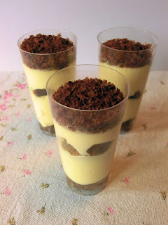 Finger-food dessert shooter of tiramisu mousse with coffea and liqueur mascarpone cream