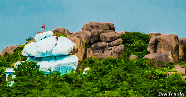 Shrine in boulders as seen from Taramati Baradari temple with Red flag near Taramati Baradari