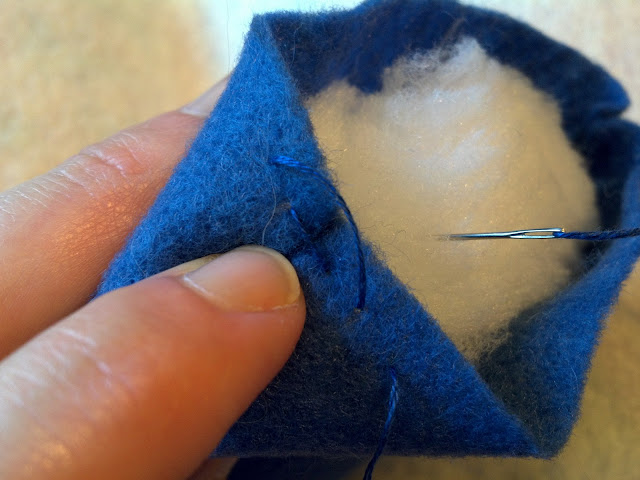 Stitches should go across the seam (two stitches shown)