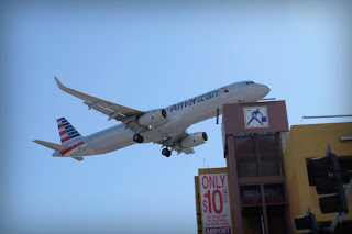 An American Airlines airbus barely clears a parking garage