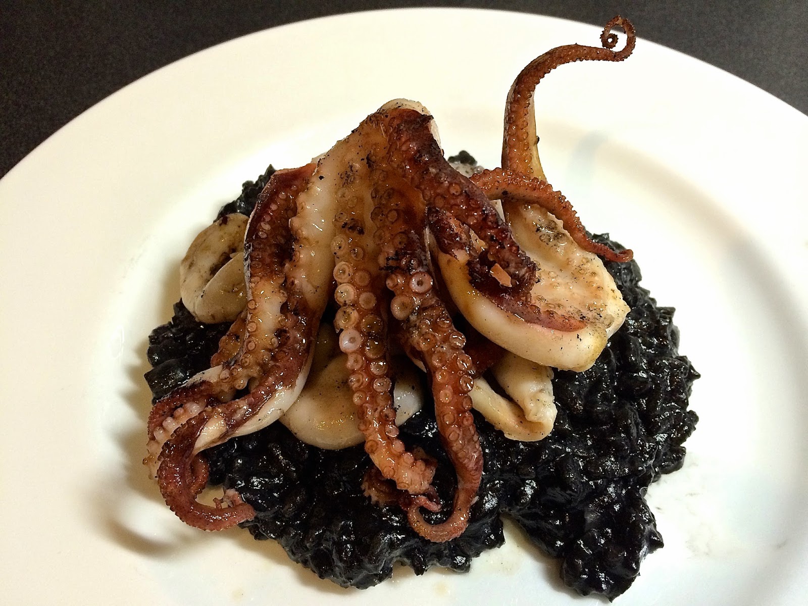 Barbequed baby octopus with squid ink risotto.