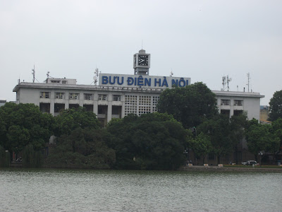 Green trees surrounding Hoan Kiem Lake