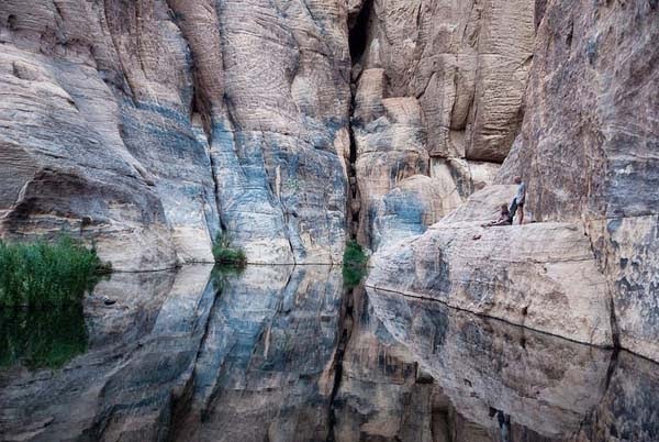 The cool waters are sheltered by sandstone cliffs. -There’s A Place You Can Barely See In The Middle Of The Desert. But When You Go Closer… AMAZING. The cool waters are sheltered by sandstone cliffs. -There’s A Place You Can Barely See In The Middle Of The Desert. But When You Go Closer… AMAZING.
