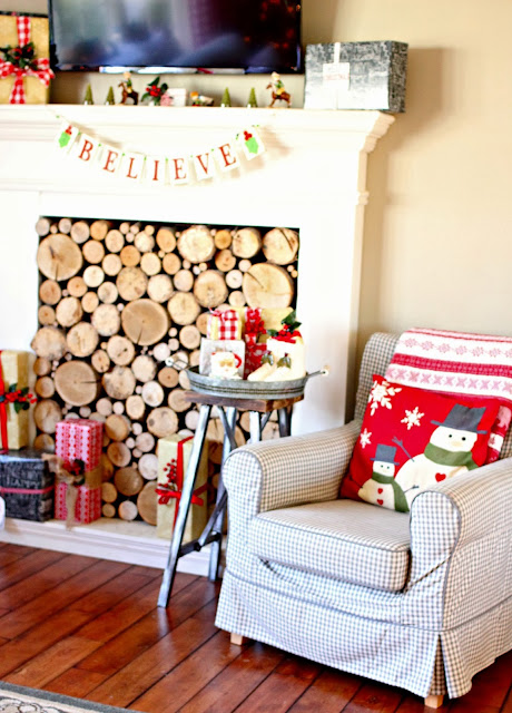 Ikea grey check Jennylund chair and faux fireplace with stacked logs-www.goldenboysandme.com