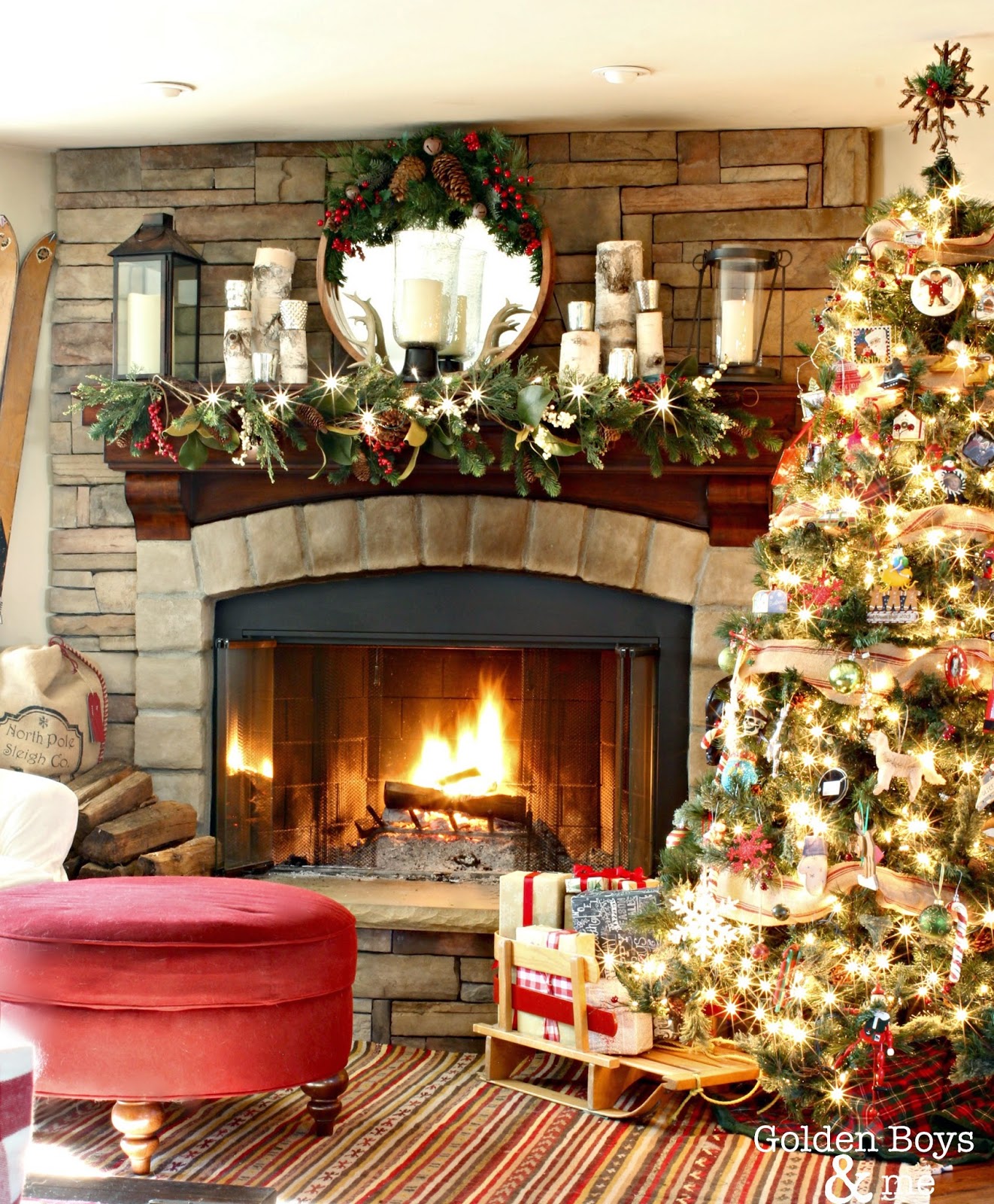 Rustic lodge style family room at Christmas with corner stone fireplace and vintage wood skis-www.goldenboysandme.com