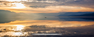 A lone kayaker on the glassy reflections of Lake Okanagan in the late fall, by Chris Gardiner Photography www.cgardiner.ca