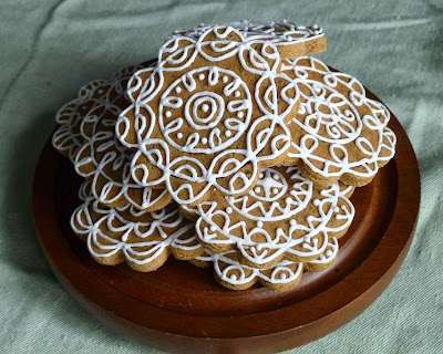 wood plate of decorated gingerbread cookies