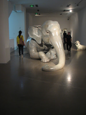 Dramatically lit, life size painted animals like the immortal one, a dopey elephant, big eyed horse, sheep, and a group of seals