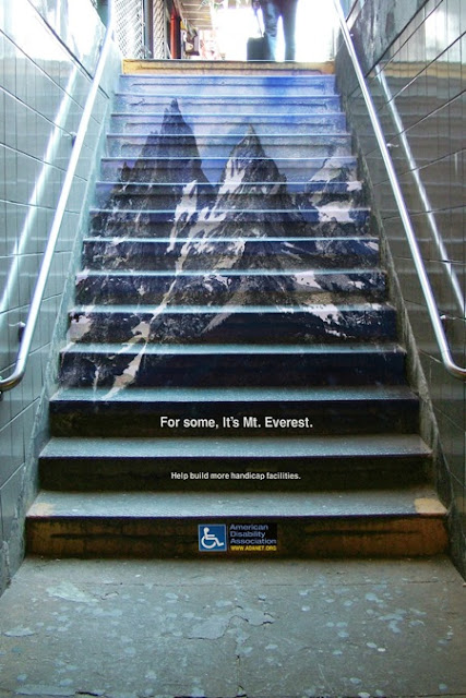 Photo of stairs with a picture of Mt Everest, depicting struggle of stairs for mobility impaired.