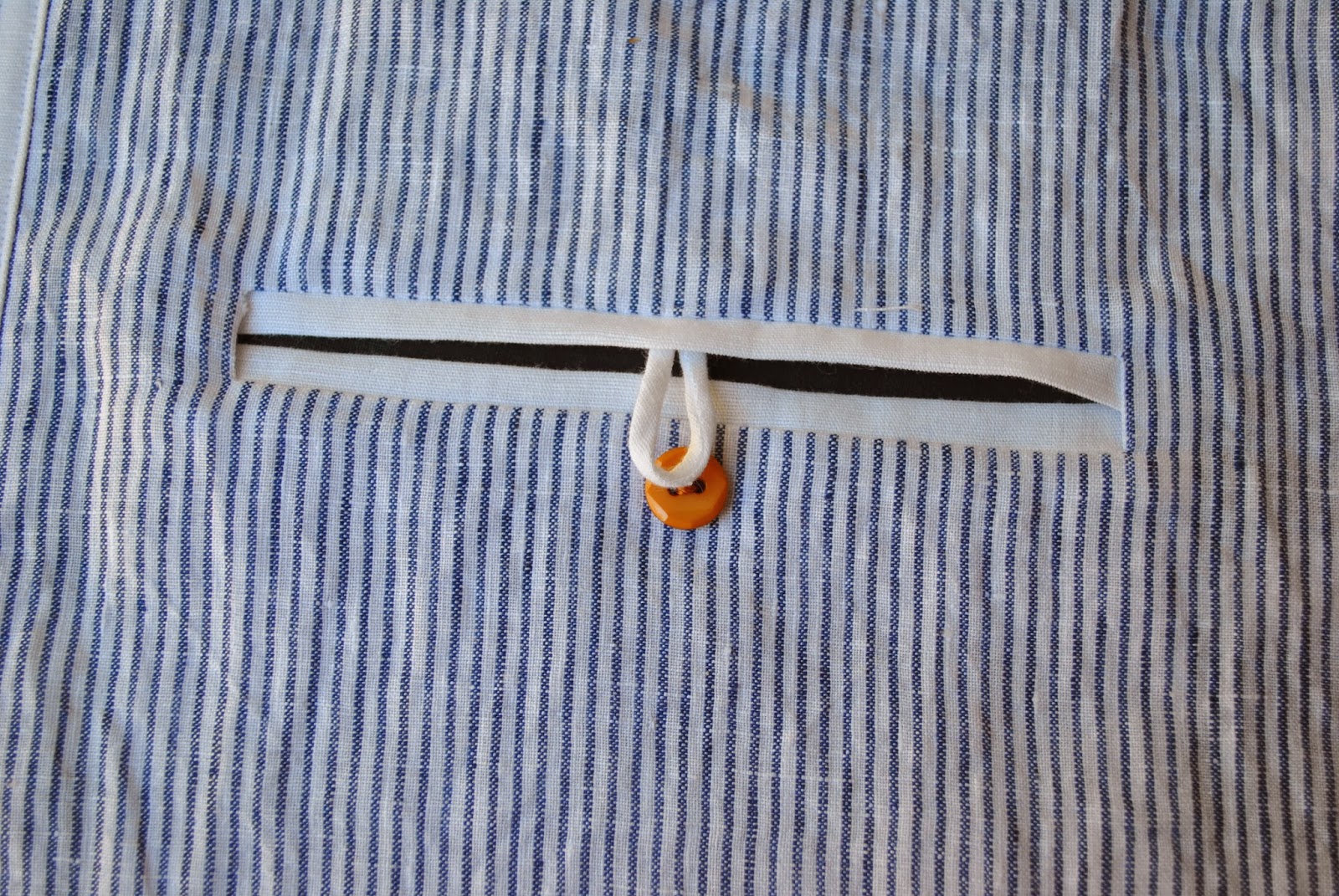 Double welt pocket with looped button closure Handmade by Carolyn