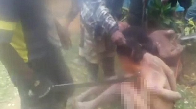 Woman stripped naked by gang video