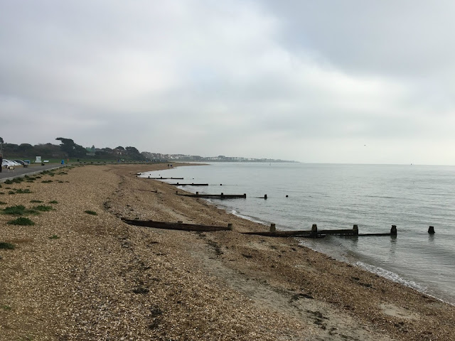 A view along the shingle beach with a very dull sky