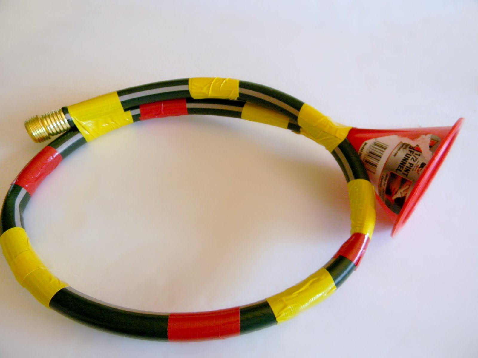 Now, you need to squish the hose down into a trumpet shape. Just