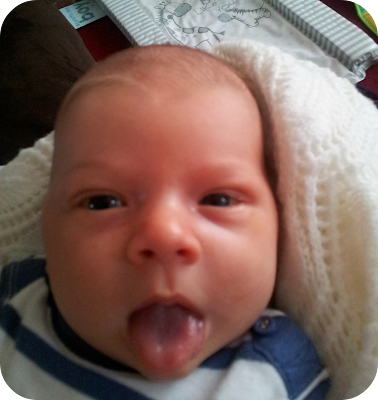 one month old baby boy, baby poking tongue out, funny face baby