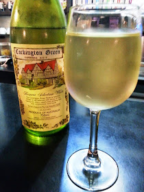 A bottle of special-label Cockington Green wine next to a glass of it.