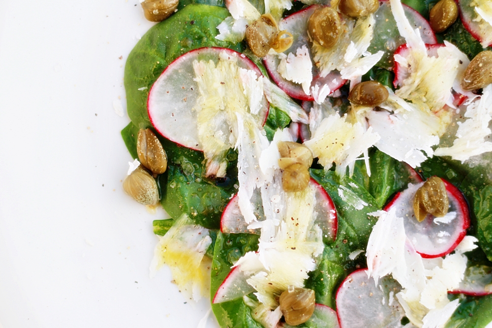 Delicious Tapas Spinach salad with capers, Parmesan cheese and