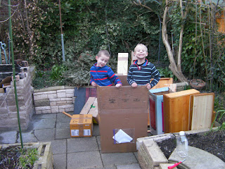 fuel for bonfire and 2 boys standing in a cardboard box
