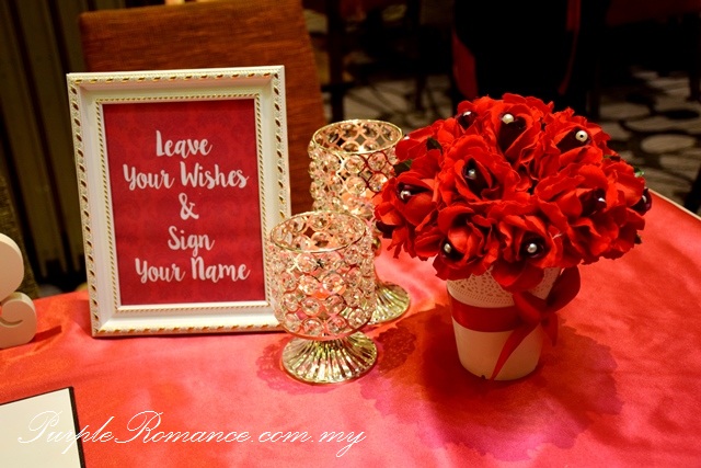 photo album table, wedding decoration, grand palace pavilion shopping mall, kuala lumpur, maroon red, roses, flower stands, backdrop printing, canvas, decorator, selangor, photographs package, VIP centerpiece, arch, pearls, photo booth, dessert bar, candy bar, reception table, love corner