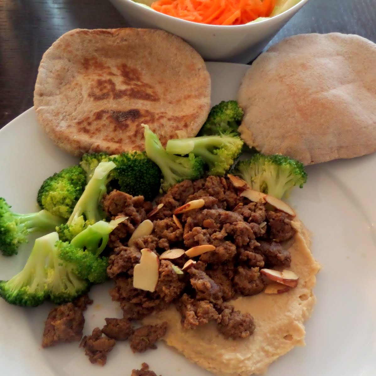 Spiced Lamb and Hummus:  Ground lamb cooked with Mediterranean spices and served atop hummus.