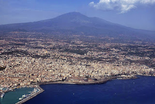 The Sicilian port city of Catania with the volcanic Mount Etna in the background