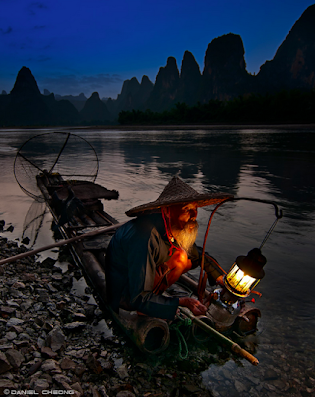 Fisherman's Blues  A cormorant fisherman on the Li River in Yangshuo, Guilin, China