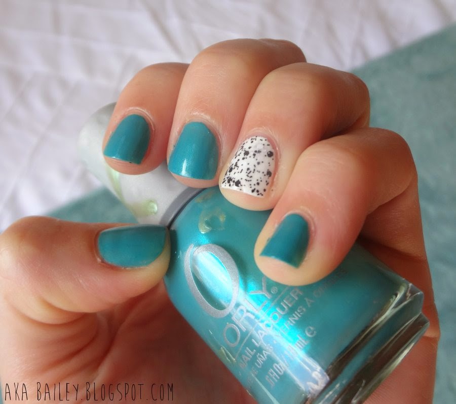Turquoise polish with black and white polka dot accent nail