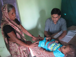 Doctor looking at a child with a woman.