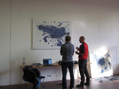 Peter with David Schnell in front of his music score or topographical landscape painting