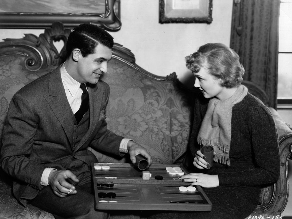 Cary Grant and his then wife Virginia Cherrill playing backgammon at home together in 1934