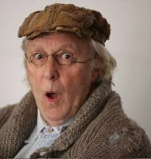 image Comedian Farquharson sporting moth eaten oatmeal hand knit sweater coat and tweed pageboy hat